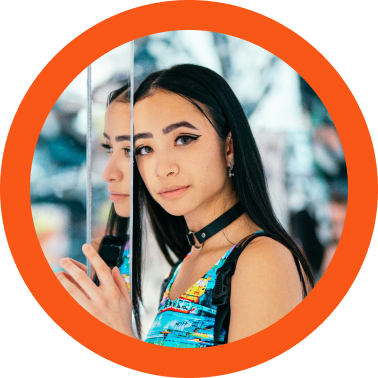 Headshot of a woman with long hair in an orange circle